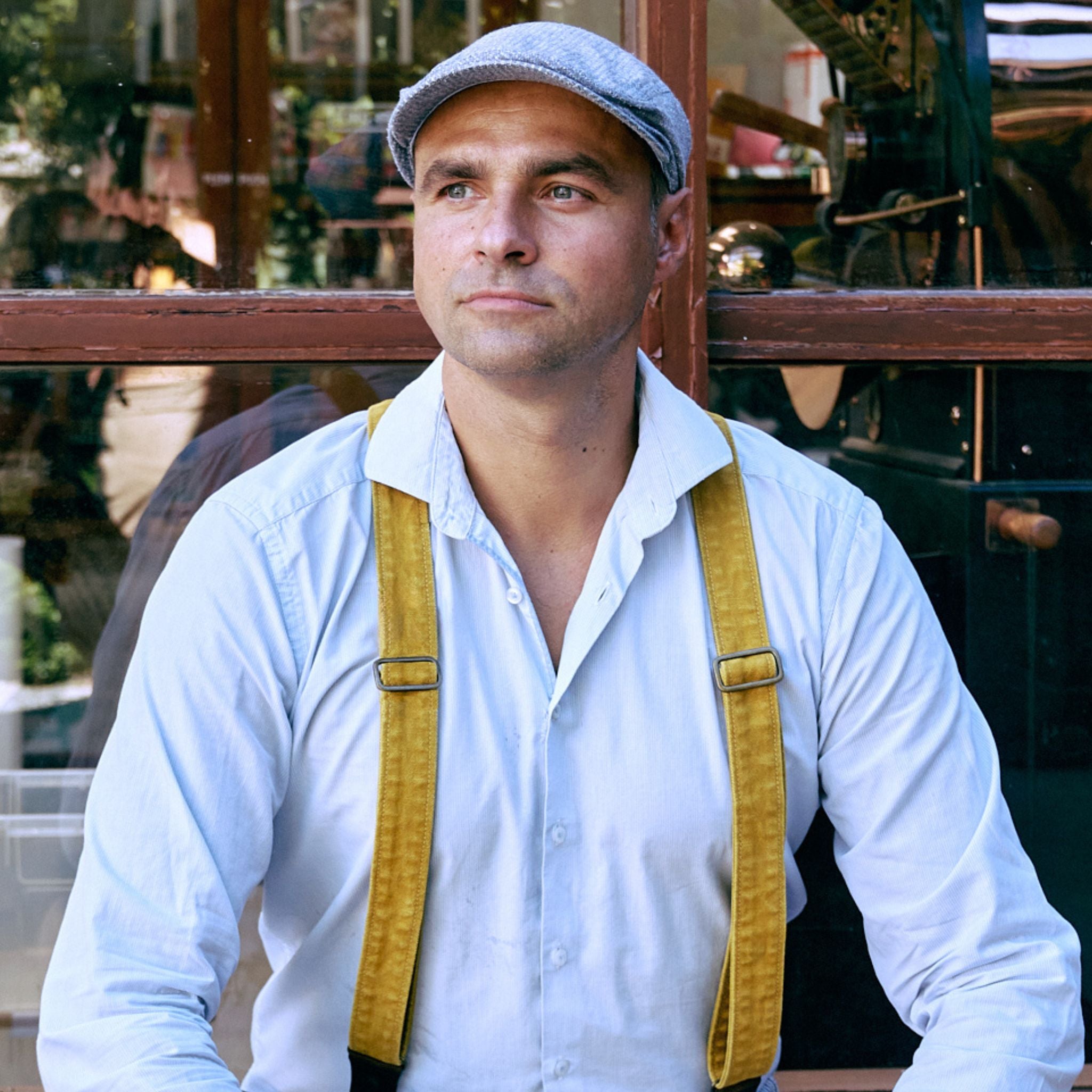 Man Wearing Wiseguy Original Mustard Duck Suspenders and a flatcap 